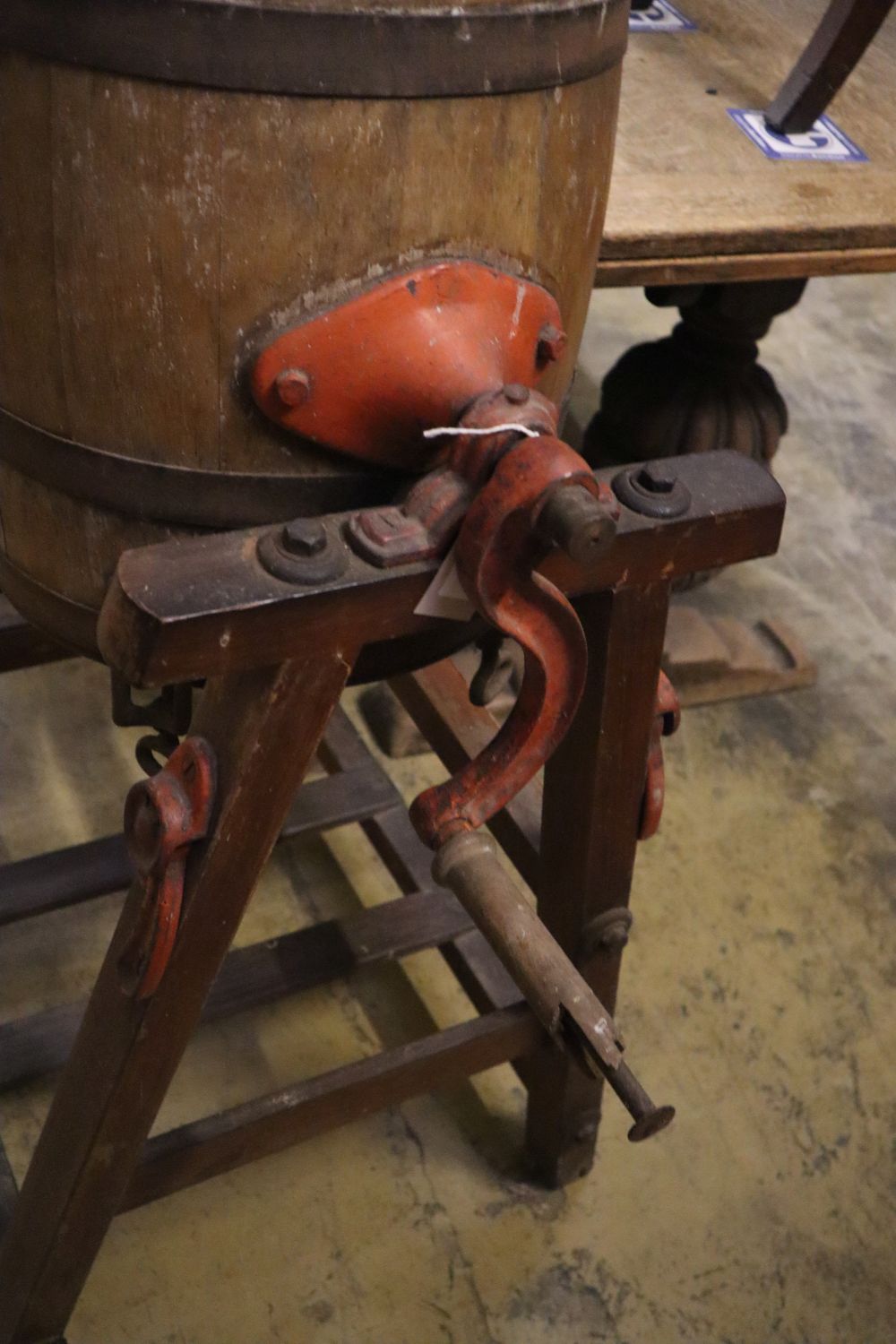 An early 20th century butter churn and two butter pats, width 64cm height 103cm